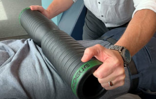 A rolling weight being applied by a provider on a patients back as a part of body tempering