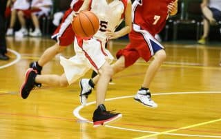 two teens running on the basketball court representing orthopedic care for teens