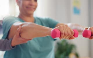 A physical therapist with patient for rehabilitation for surgery recovery.