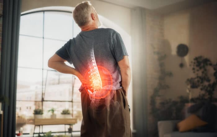 Close Up of a Senior Male Experiencing Discomfort in a Result of Spine Trauma or Arthritis.