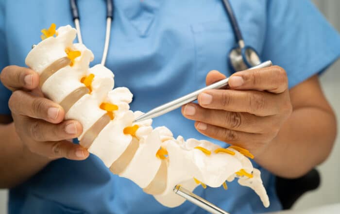 orthopedic spine doctor pointing to spine