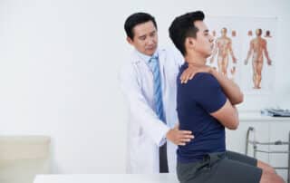 A physical therapy spine specialist with his patient in during a therapy session at the clinic.