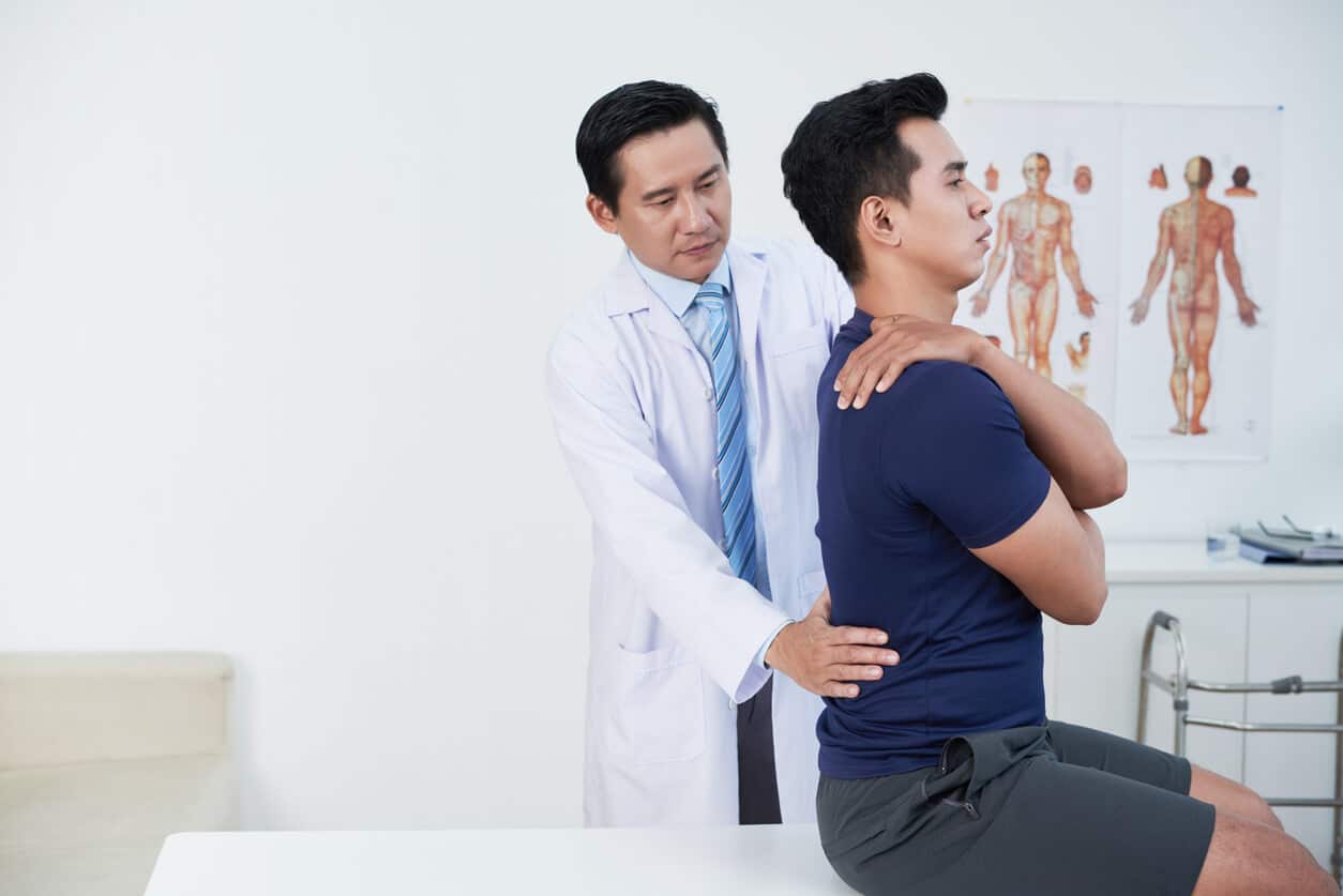 A physical therapy spine specialist with his patient in during a therapy session at the clinic.