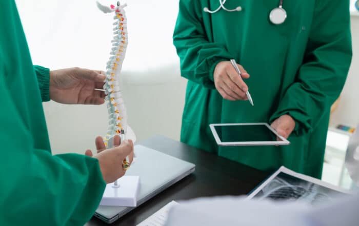 The doctor joins a meeting with the surgeon's team to discuss a plan for Minimally invasive spine surgery (MISS).