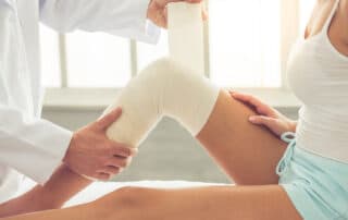 A female patient receiving care at an orthopedic urgent care center.