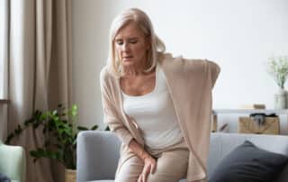 Elderly 60s woman suffer from chronic back ache.