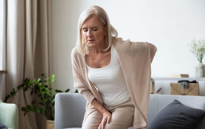 Elderly 60s woman suffer from chronic back ache.