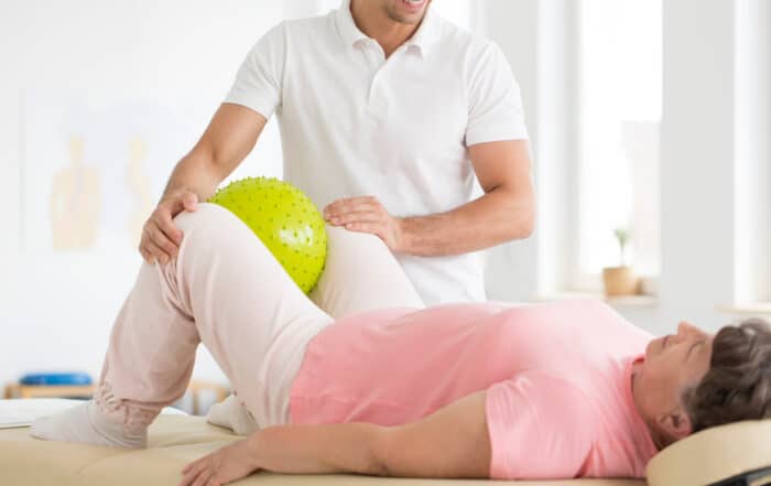 Senior woman during physical rehabilitation and therapy after hip replacement.